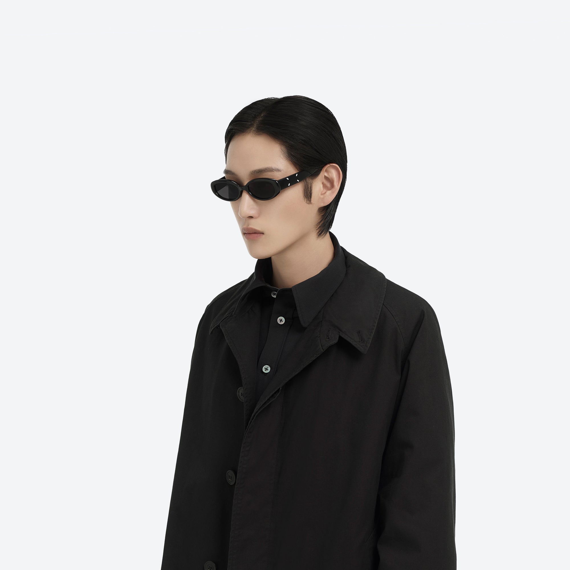 Model wearing the Maison Margiela - MM206 01 Black Acetate framed Oval sunglasses.