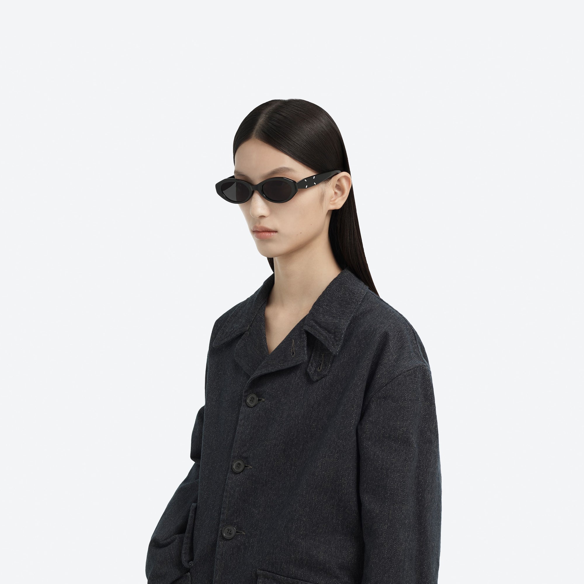 Model wearing the Maison Margiela - MM204 01 Black Acetate framed Oval sunglasses.