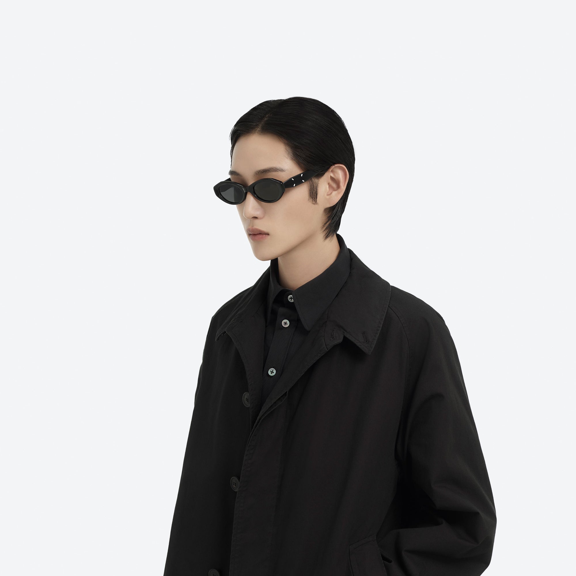 Model wearing the Maison Margiela - MM204 01 Black Acetate framed Oval sunglasses.