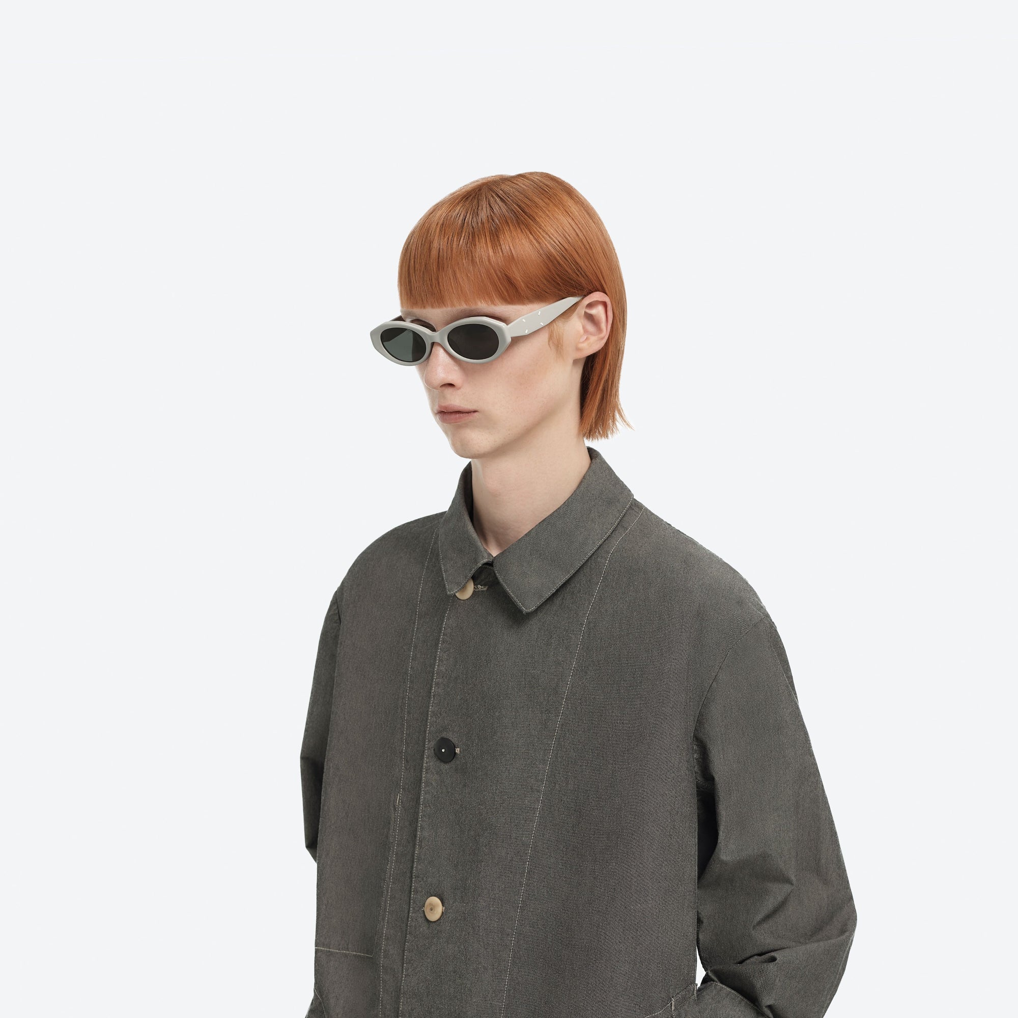 Model wearing the Maison Margiela - MM204 G12 Gray Acetate framed Oval sunglasses.