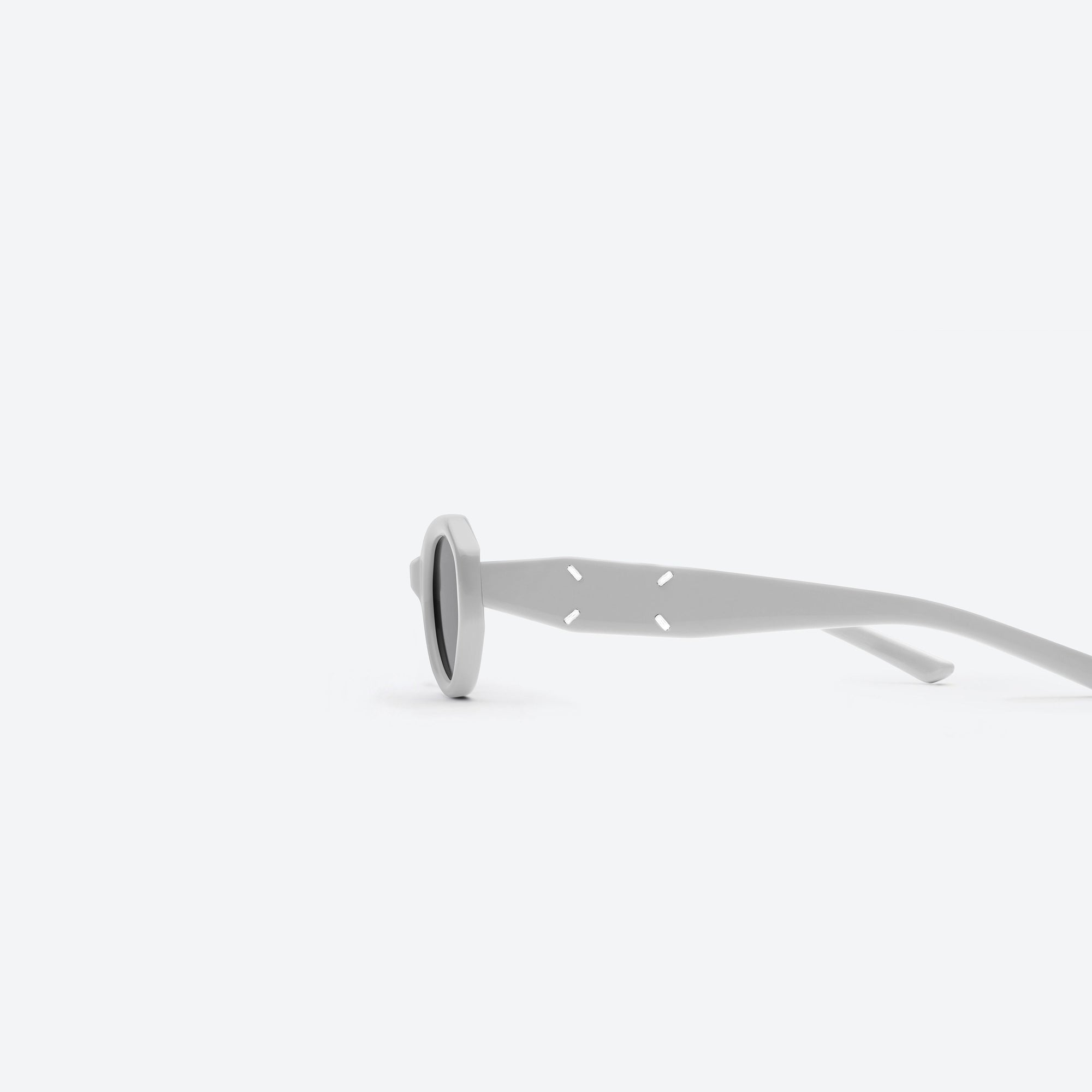 A detailed left view of Gentle Monster Maison Margiela - MM204 G12 Gray Acetate framed Oval sunglasses.