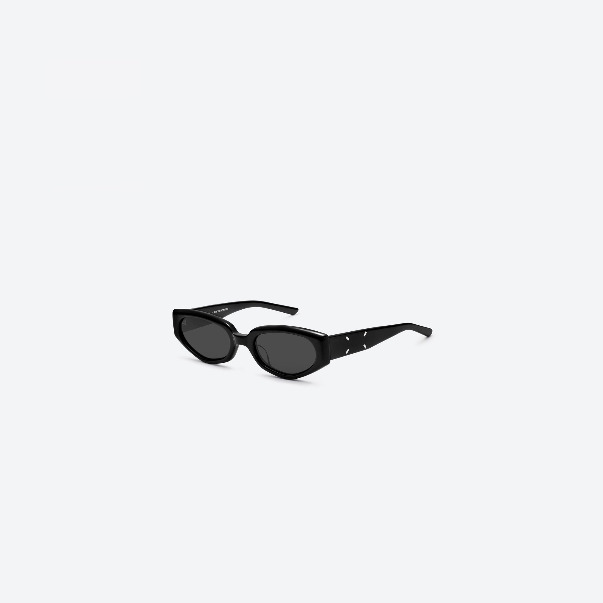 45-degree view of Gentle Monster Maison Margiela - MM205 01 Black Acetate framed Cat-eye sunglasses.