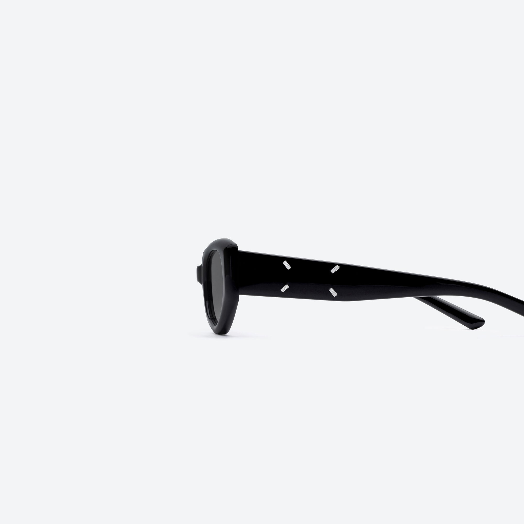 A detailed left view of Gentle Monster Maison Margiela - MM205 01 Black Acetate framed Cat-eye sunglasses.