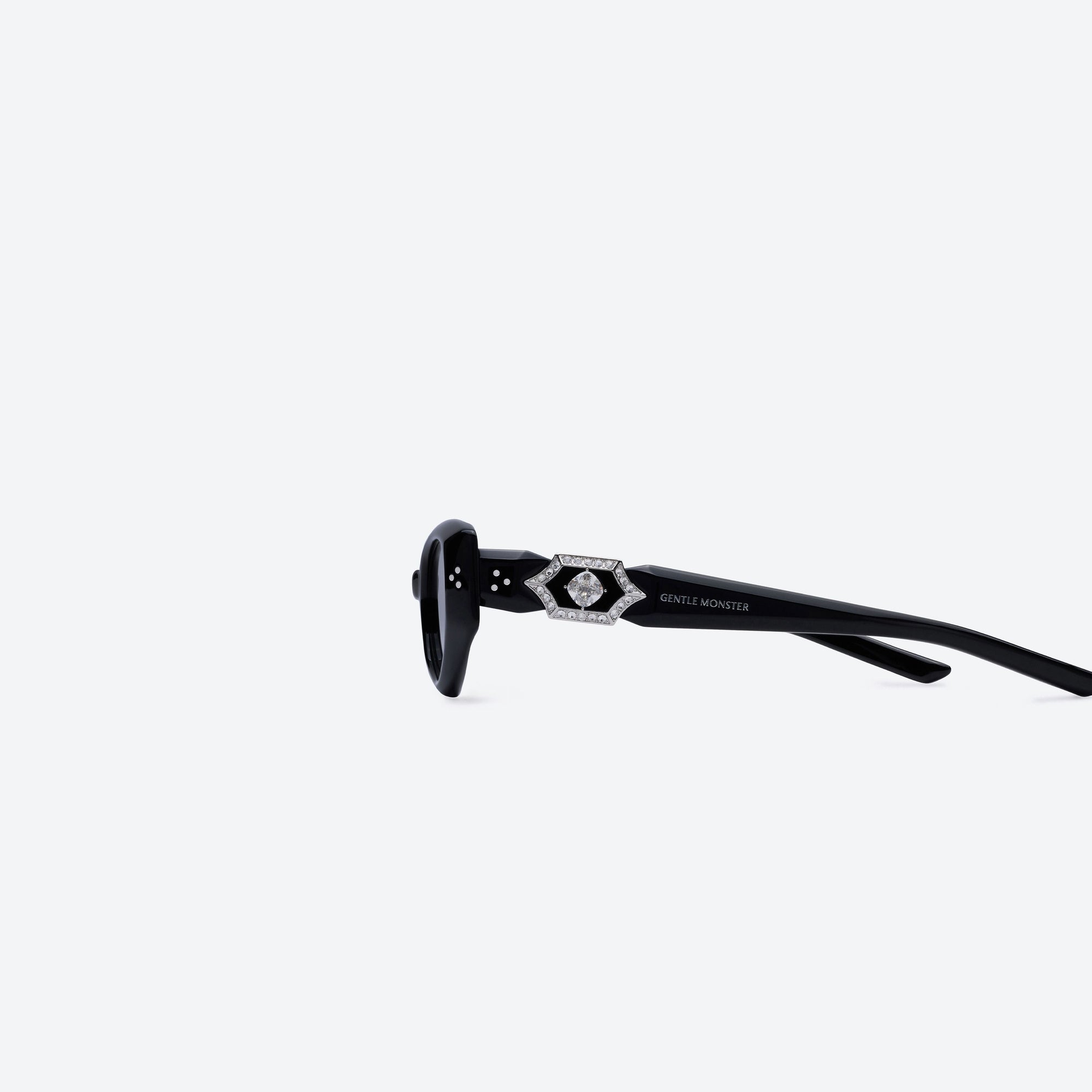 A detailed left view of Gentle Monster Ruvy Van 01 Black Acetate framed Cat-eye sunglasses.