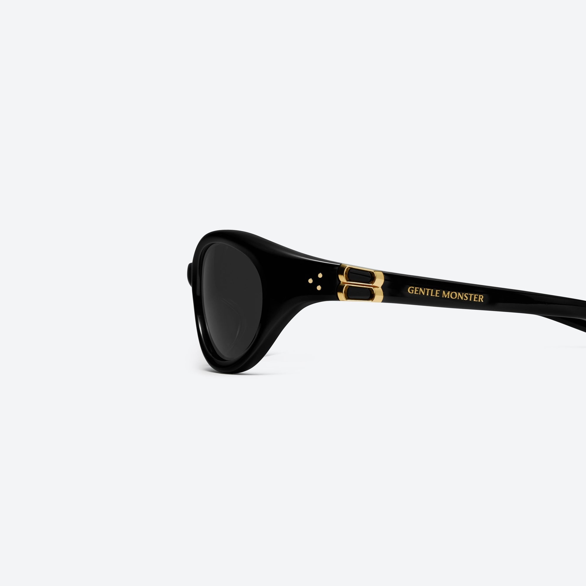 A detailed left view of Gentle Monster Ion 01 Black Acetate framed Wraparound sunglasses.