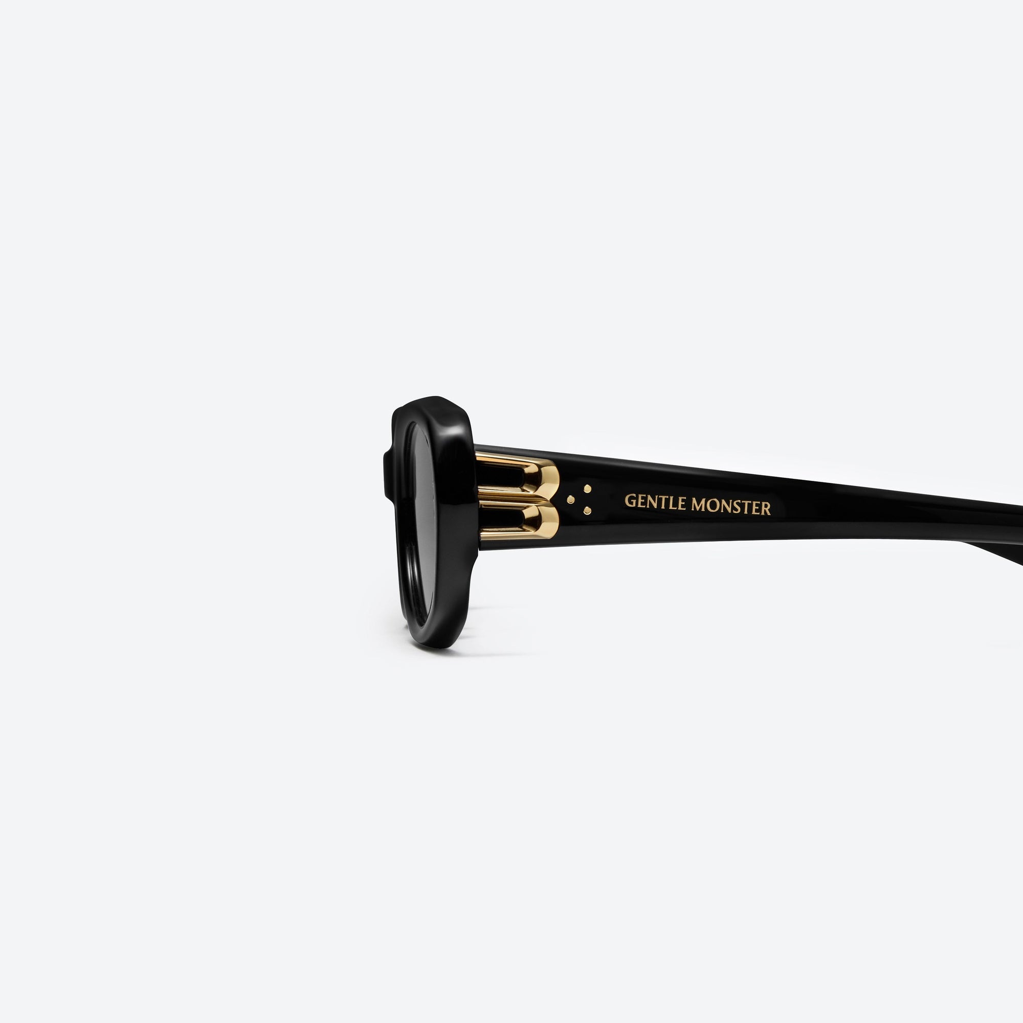 A detailed left view of Gentle Monster Ninishe 01 Black Acetate framed Oval sunglasses.