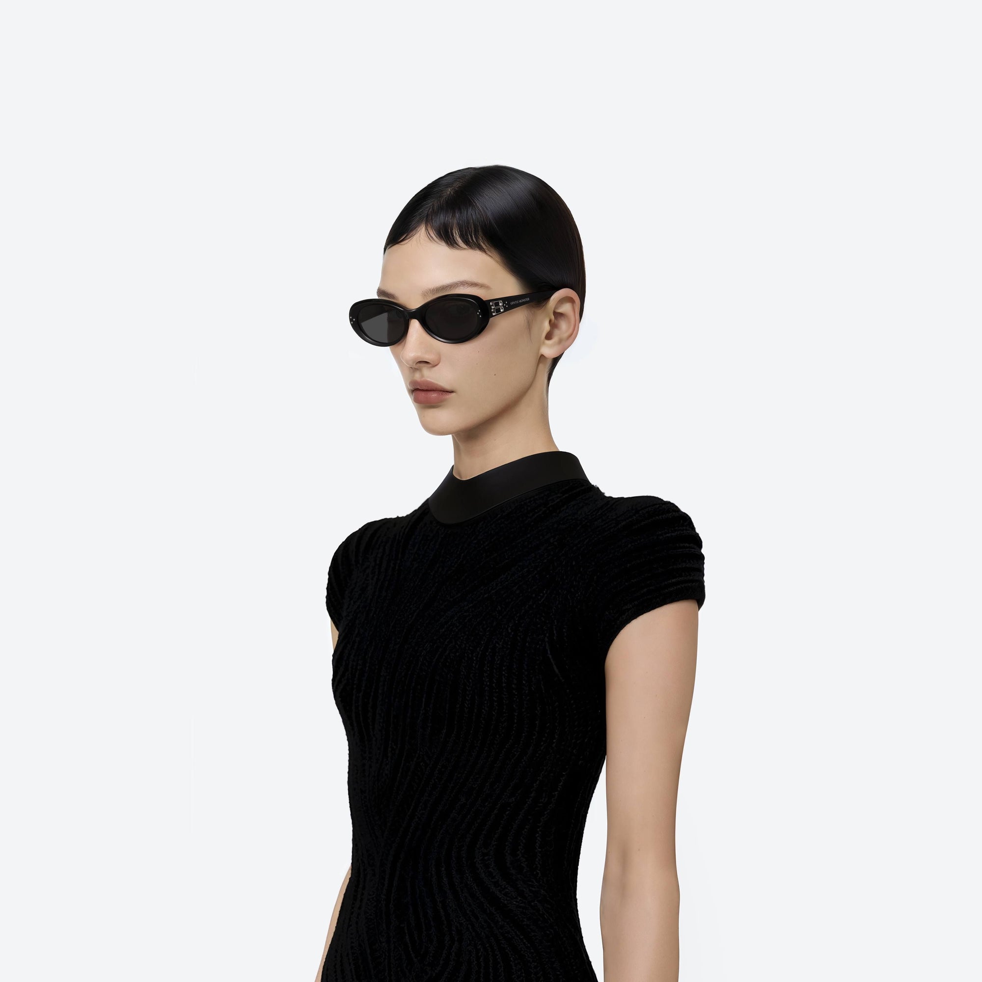 Model wearing the Cocoa 01 Black Acetate framed Oval sunglasses.