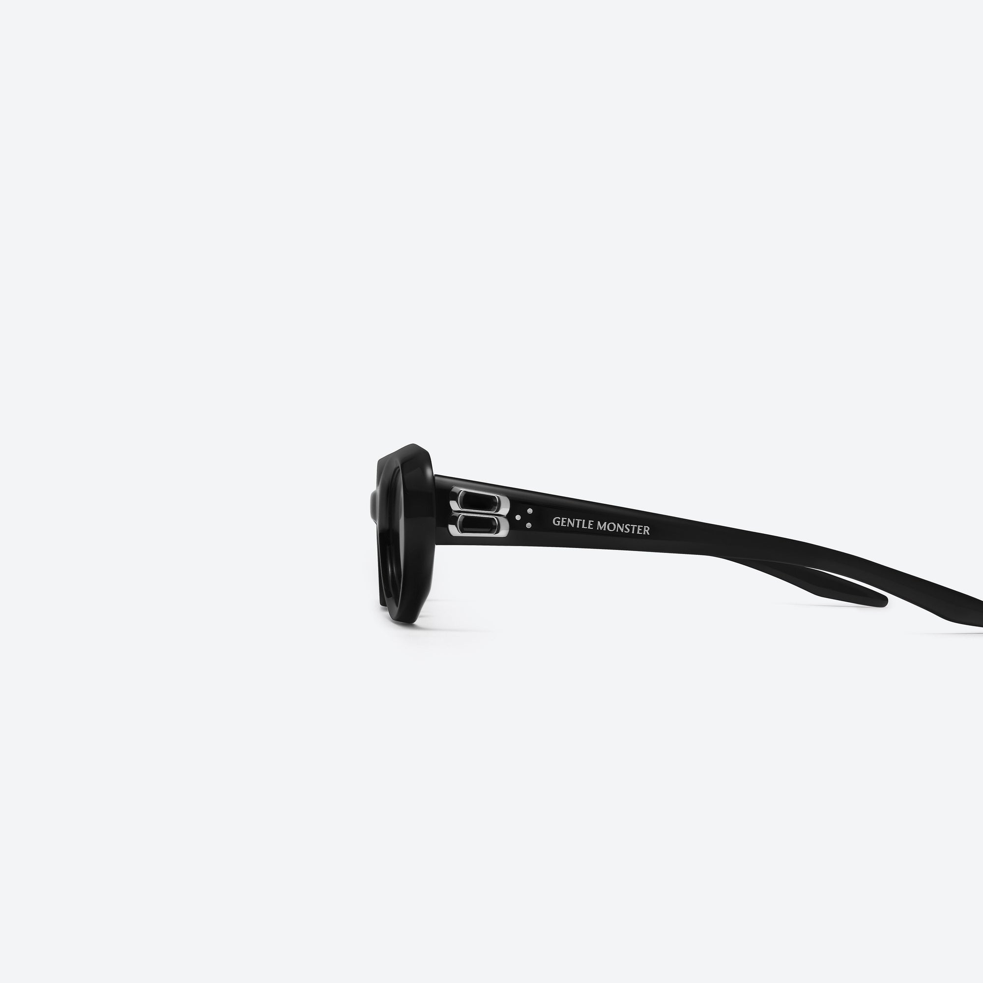 A detailed left view of Gentle Monster Cocoa 01 Black Acetate framed Oval sunglasses.
