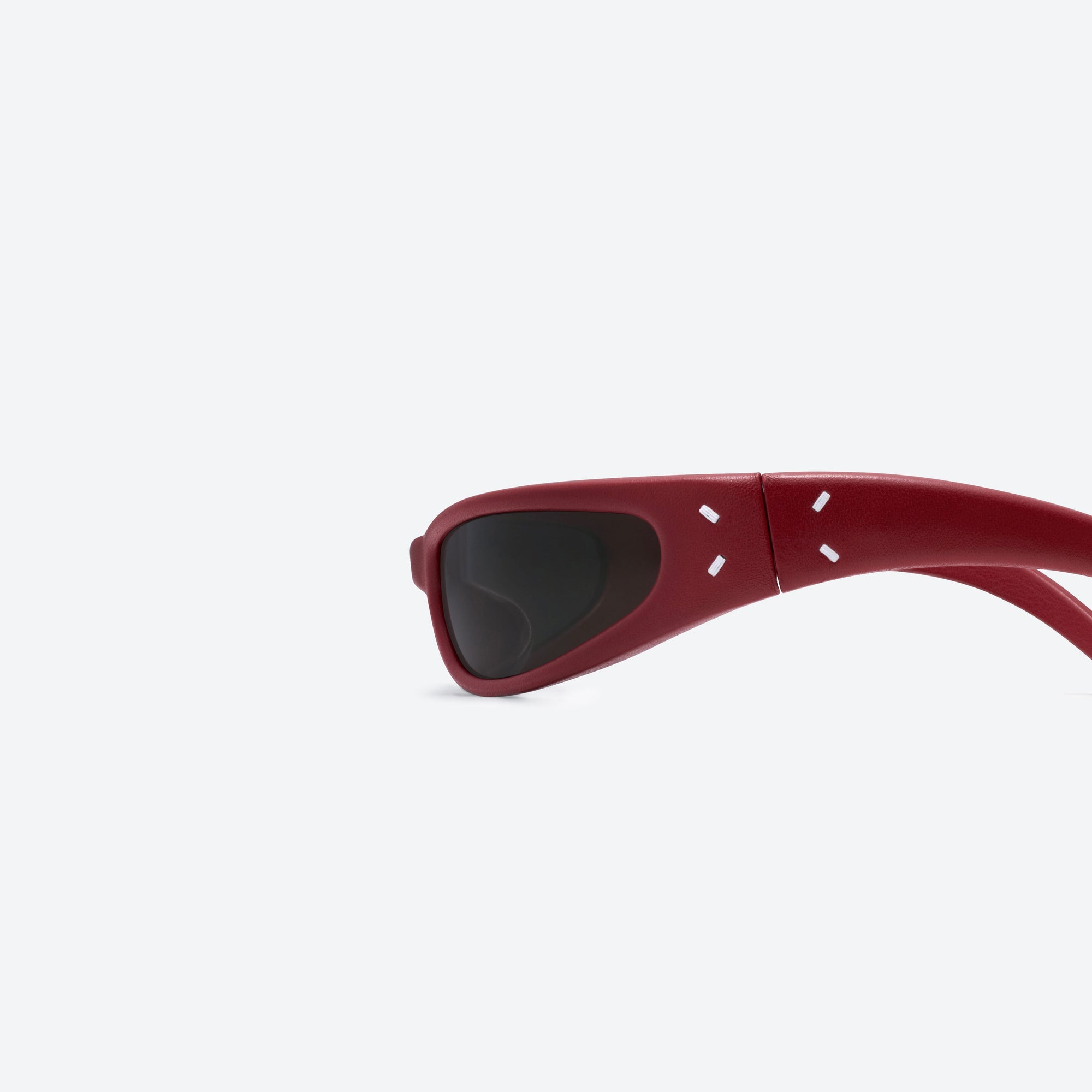 A detailed left view of Gentle Monster Maison Margiela - MM203 Leather LR1 Red Acetate framed Oval sunglasses.