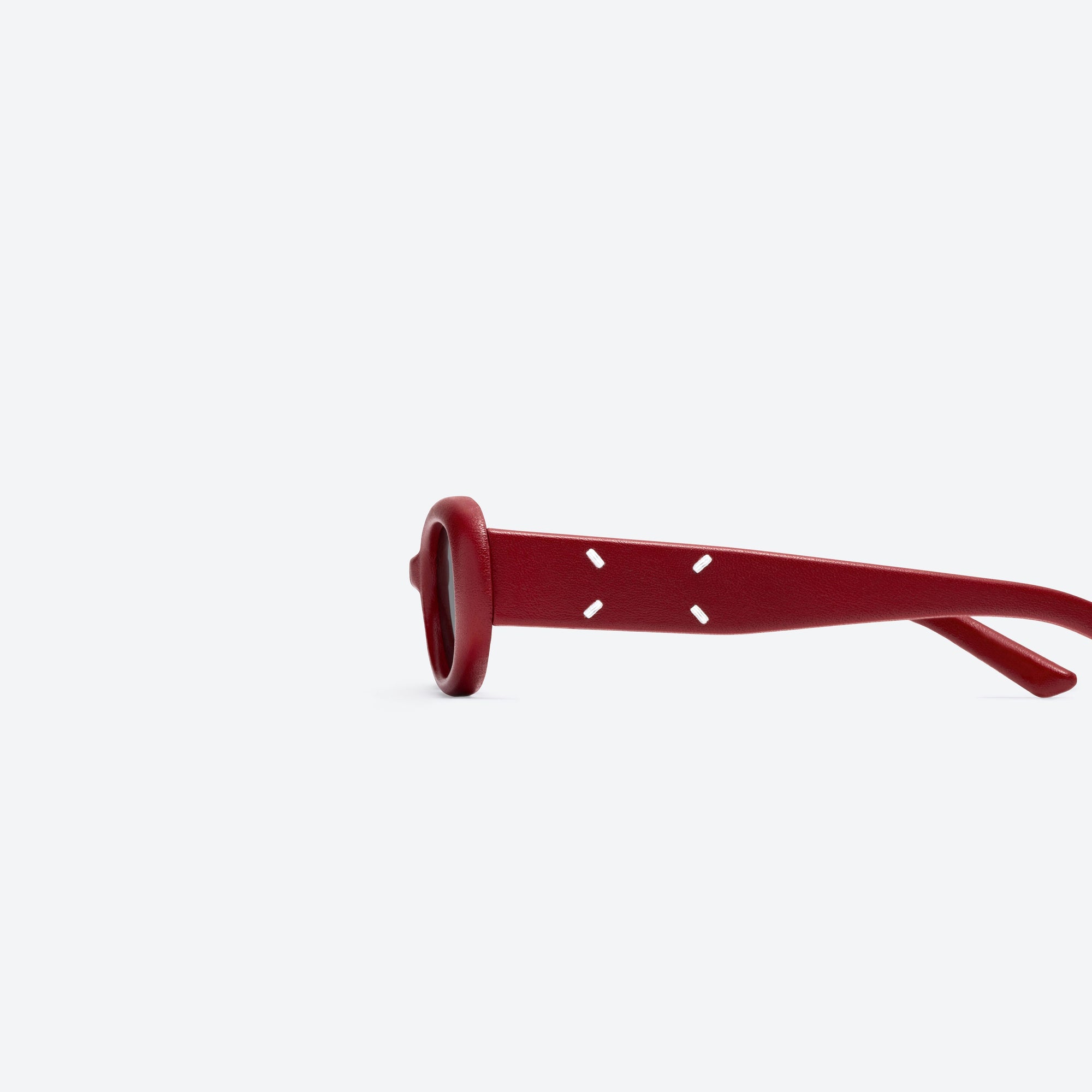 A detailed left view of Gentle Monster Maison Margiela - MM206 Leather LR1 Red Acetate framed Oval sunglasses.