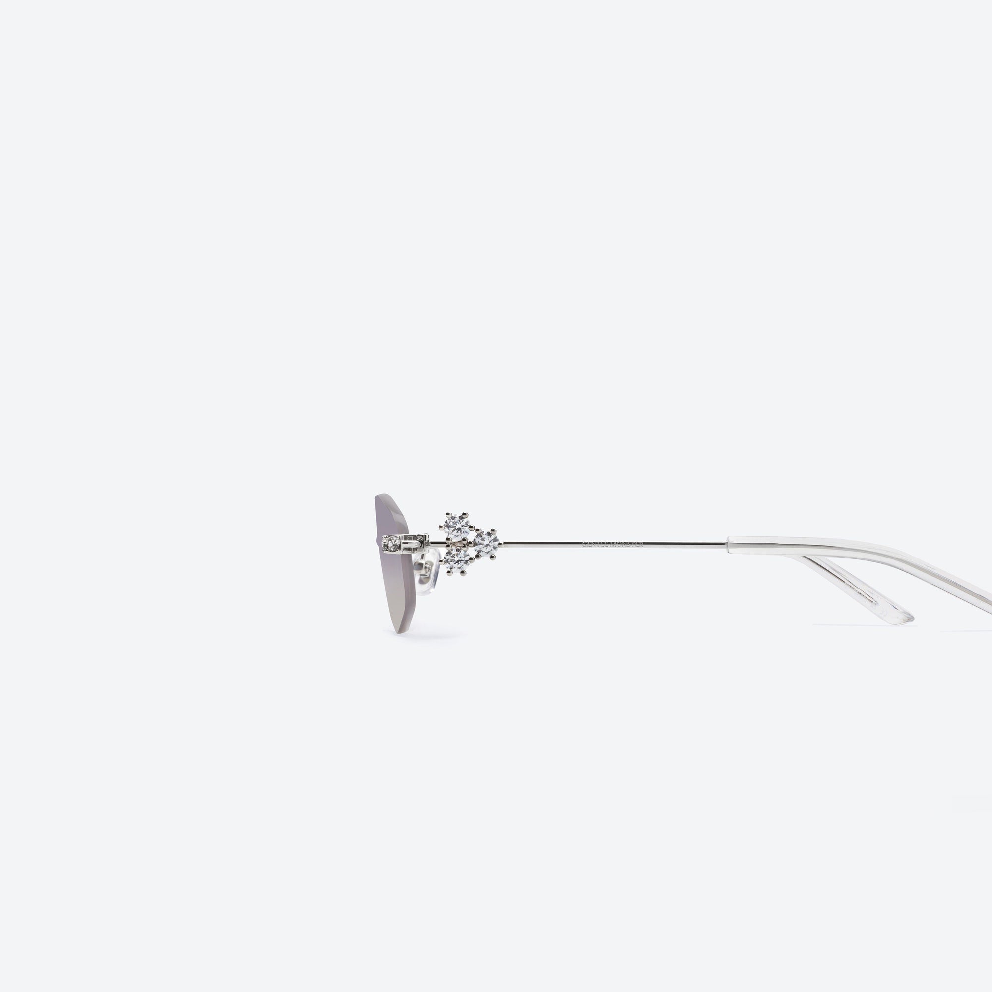 A detailed left view of Gentle Monster Glitz 02(VYG) Silver Metal framed Oval sunglasses.