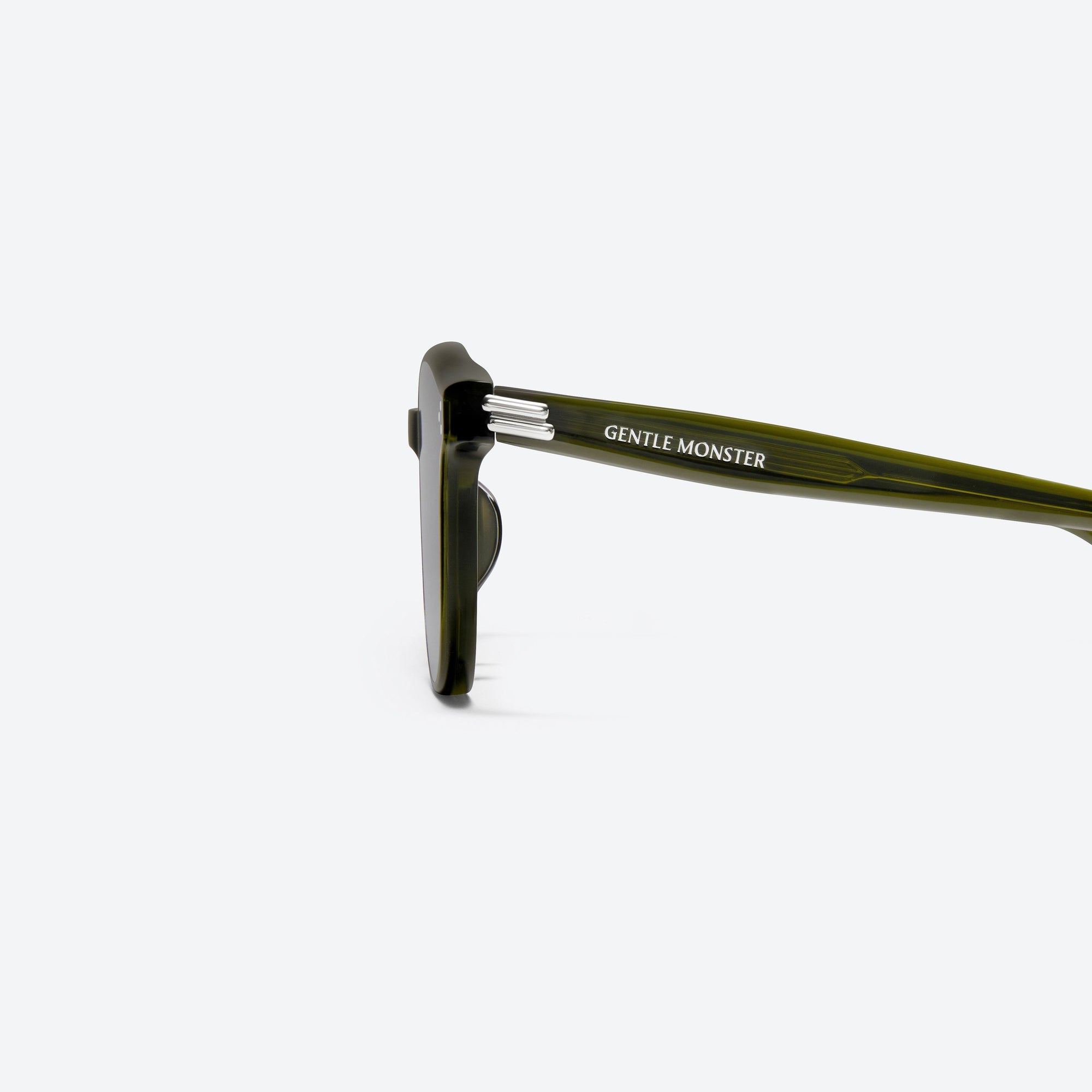 A detailed left view of Gentle Monster Dean KC2 Green Acetate framed Round sunglasses.