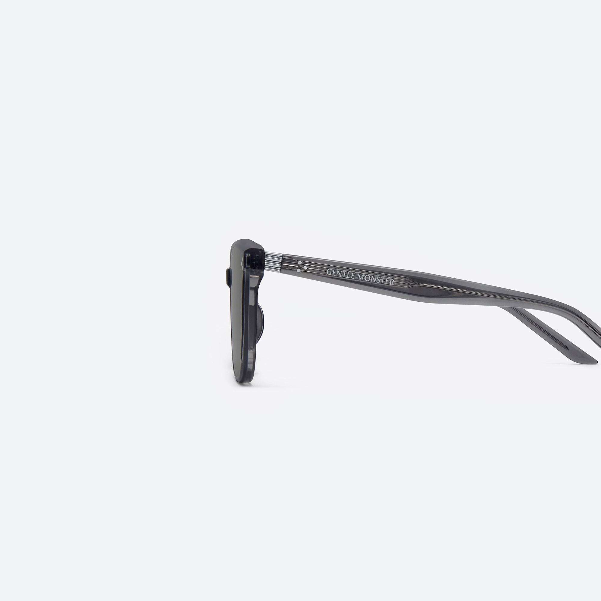 A detailed left view of Gentle Monster By Row GC12 Gray Acetate framed Square sunglasses.