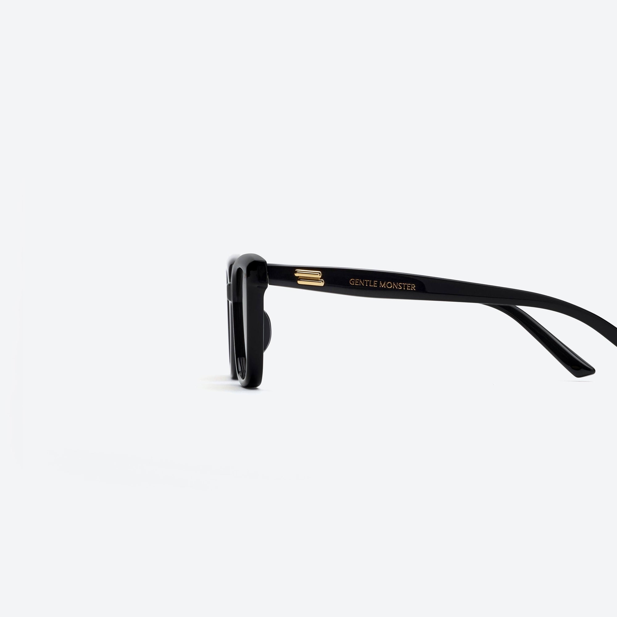 A detailed left view of Gentle Monster Breezebe 01(BR) Black Acetate framed Square sunglasses.