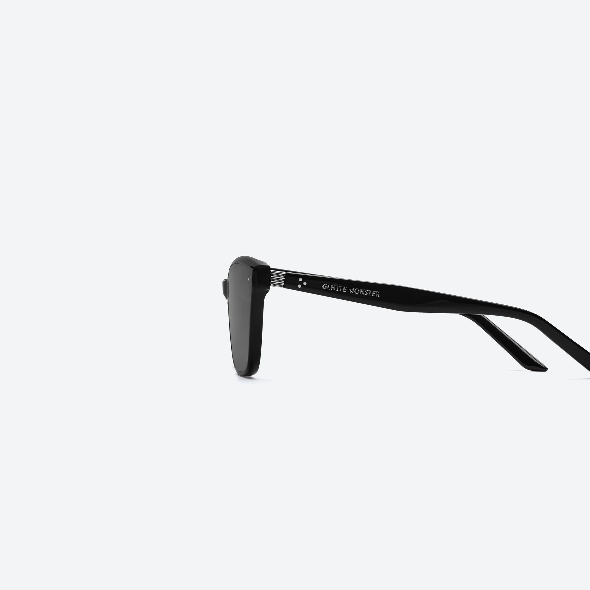 A detailed left view of Gentle Monster Numer 01 Black Acetate framed Square sunglasses.