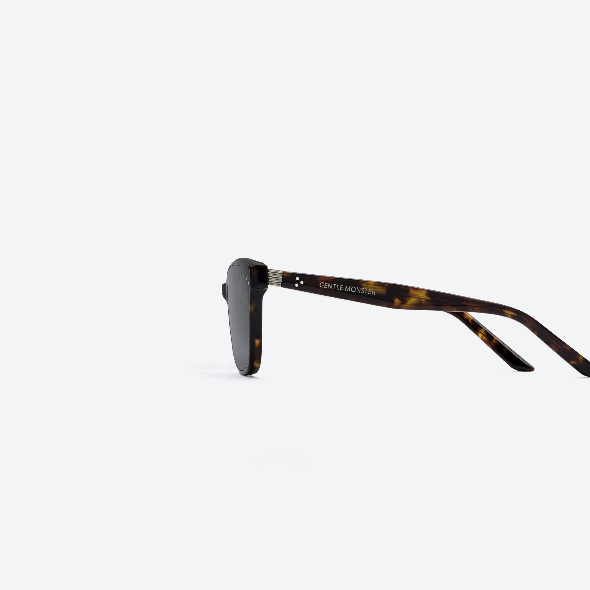 A detailed left view of Gentle Monster Numer T1 Tortoise Acetate framed Square sunglasses.