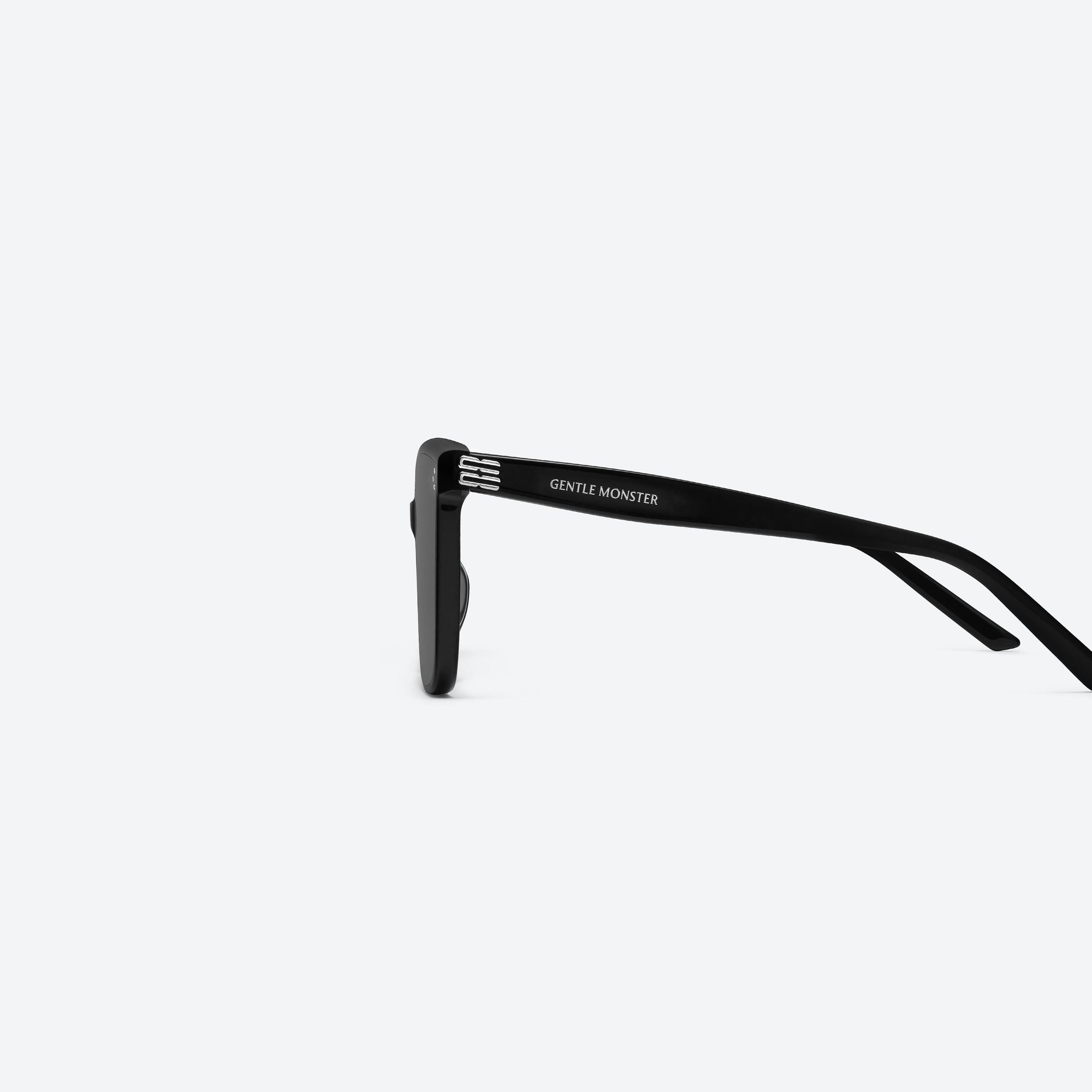 A detailed left view of Gentle Monster Piana 01(G) Black Acetate framed Square sunglasses.