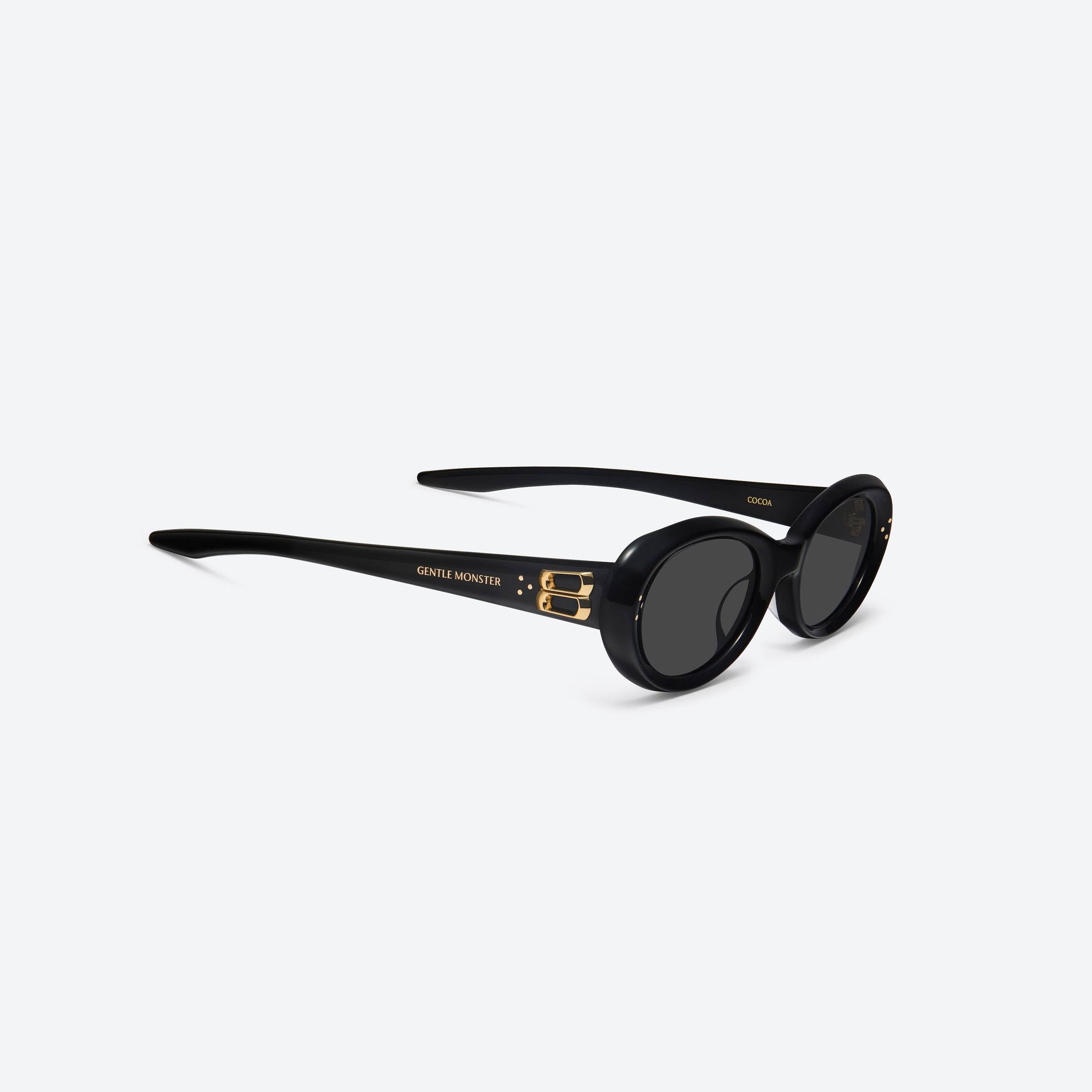 45-degree detailed view of Gentle Monster Cocoa 01GD Similar Black Acetate framed Oval sunglasses.