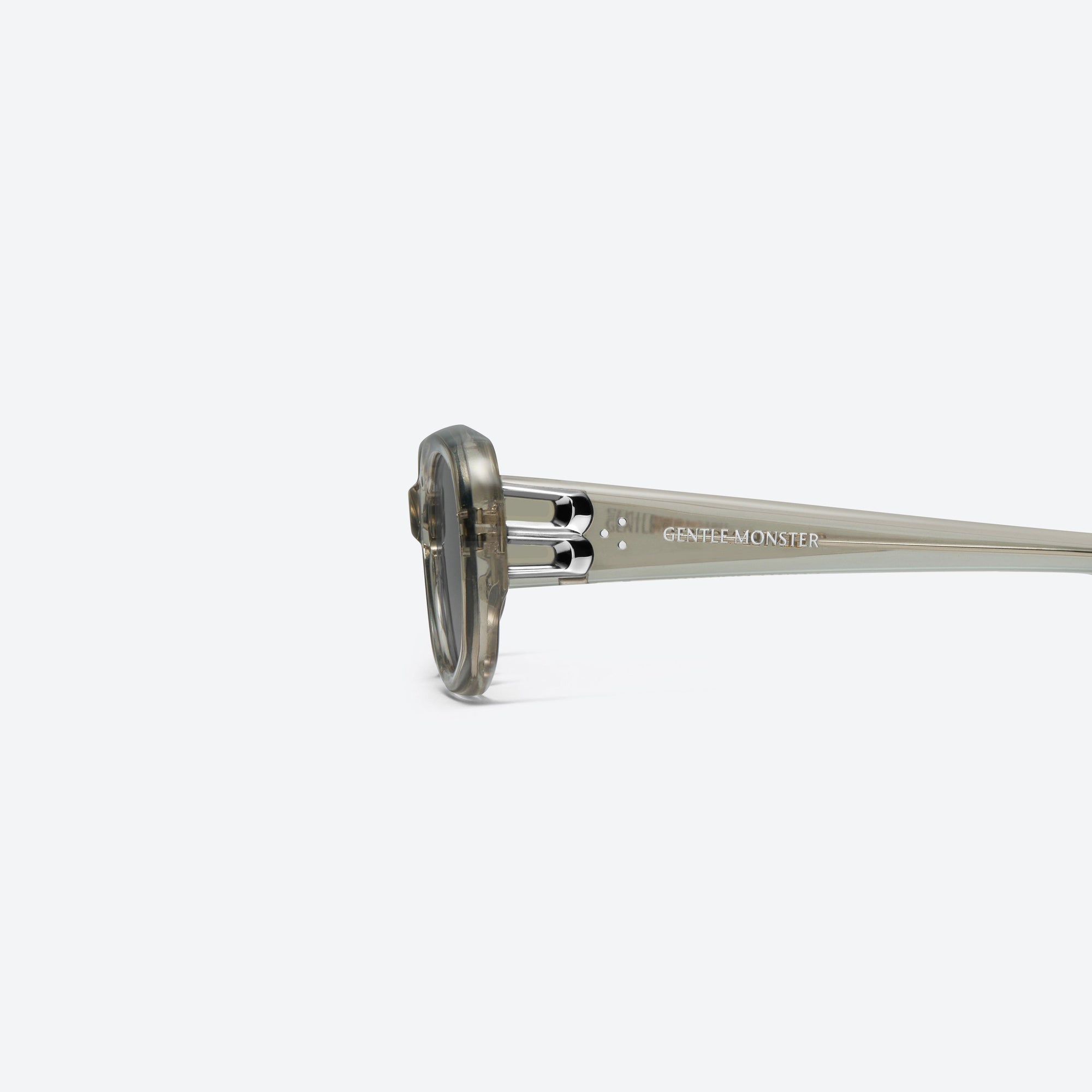 A detailed left view of Gentle Monster Ninishe BRC11 Brown Acetate framed Oval sunglasses.