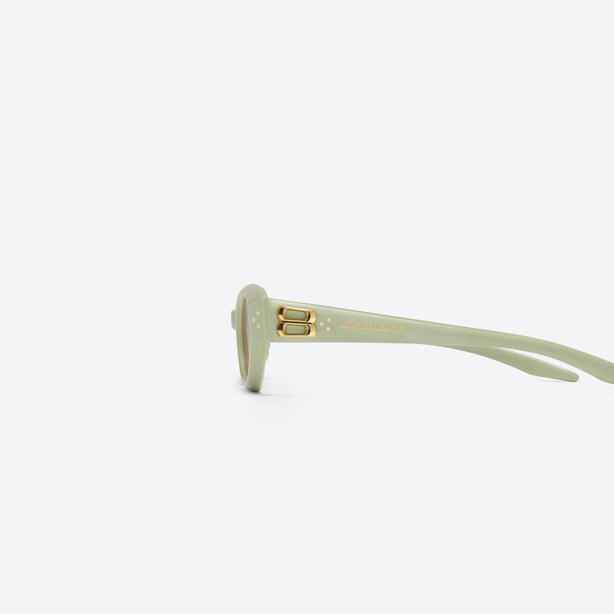 A detailed left view of Gentle Monster Duns Gr9 Green Acetate framed Cat-eye sunglasses.