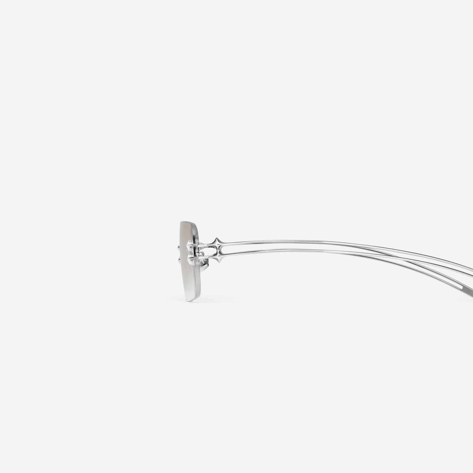 A detailed left view of Gentle Monster Tetra 02(BRM) Silver Metal framed Square sunglasses.