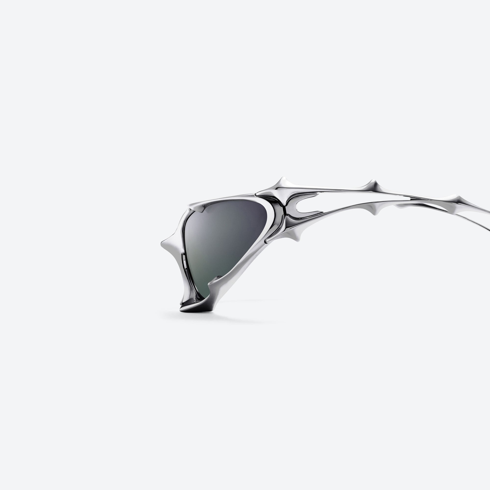 A detailed left view of Gentle Monster Goxx 02 Silver Metal framed Wraparound sunglasses.