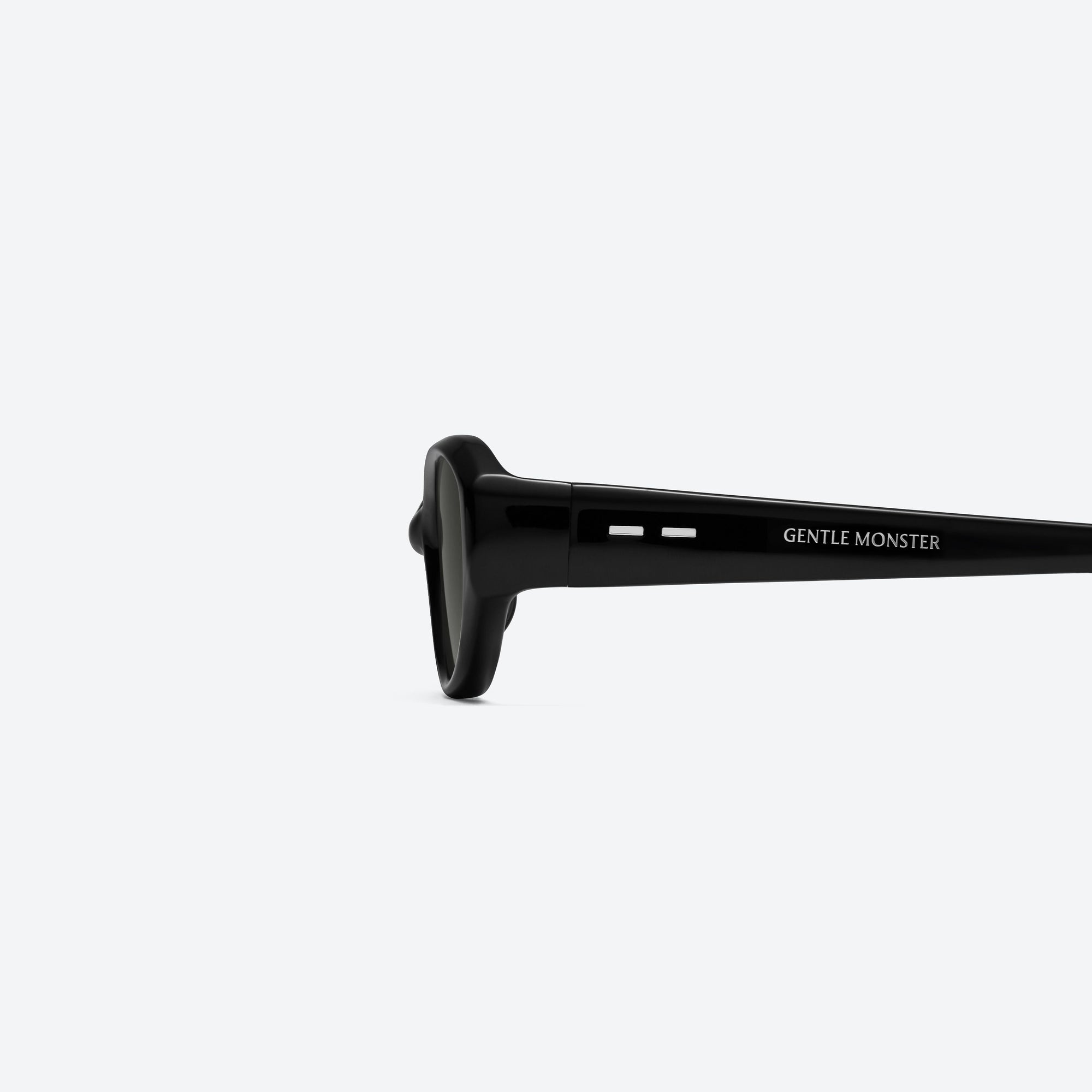 A detailed left view of Gentle Monster Monica 01 Black Acetate framed Cat-eye sunglasses.