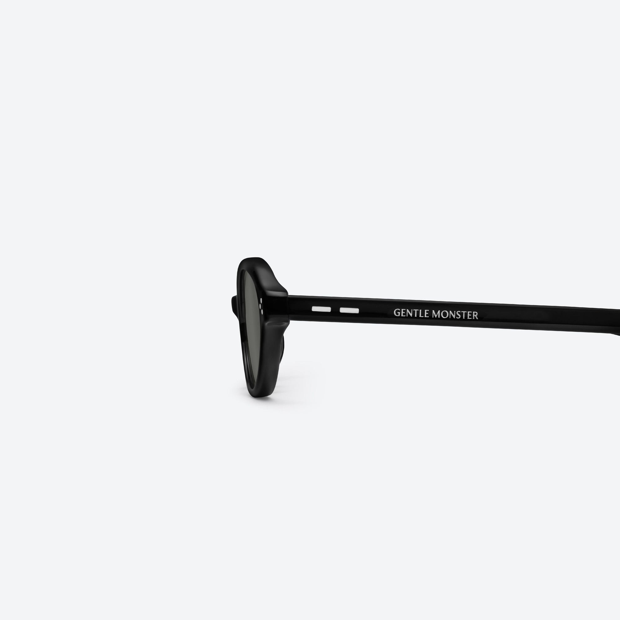 A detailed left view of Gentle Monster La Cha 01 Black Acetate framed Round sunglasses.