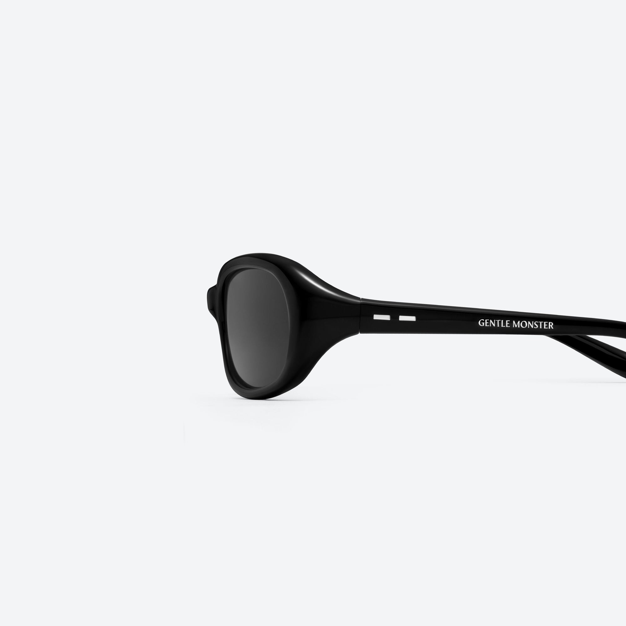 A detailed left view of Gentle Monster Groovy 01 Black Acetate framed Wraparound sunglasses.
