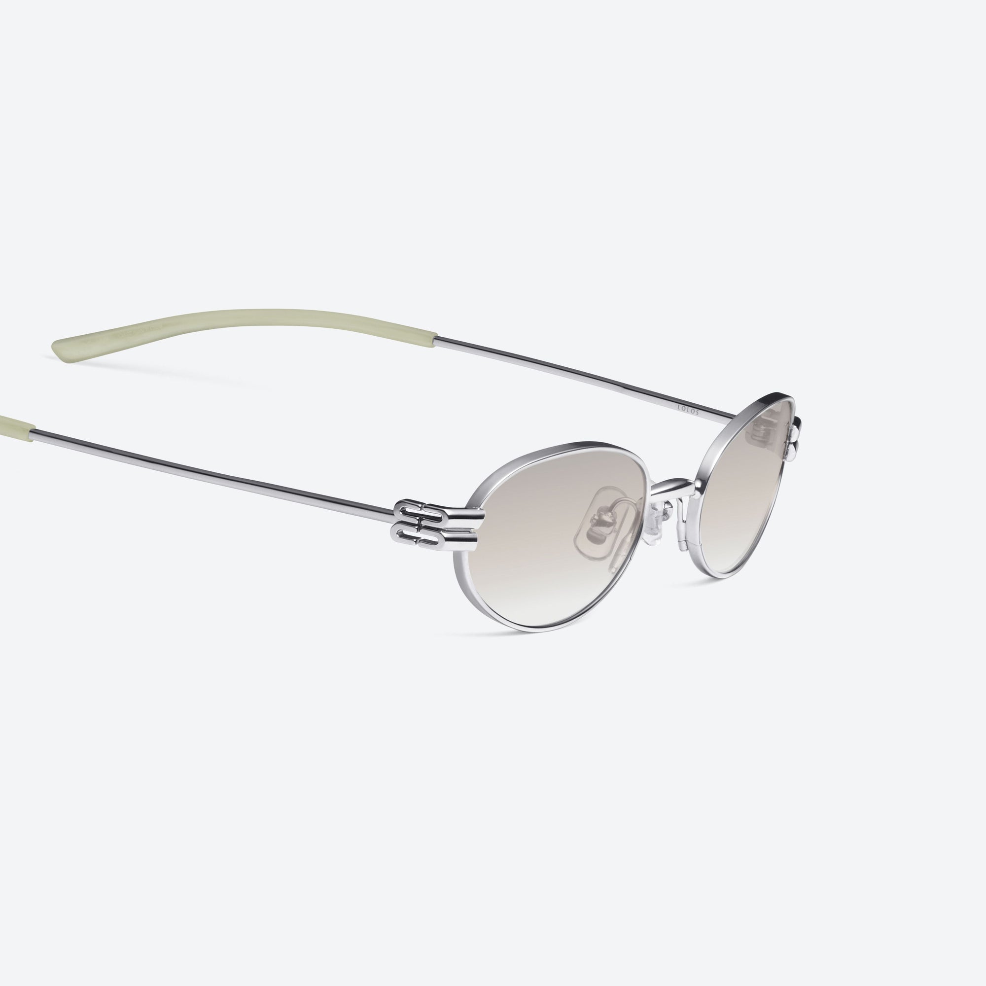 45-degree detailed view of Gentle Monster Lolos 02(BR) Similar Silver Metal framed Oval sunglasses.