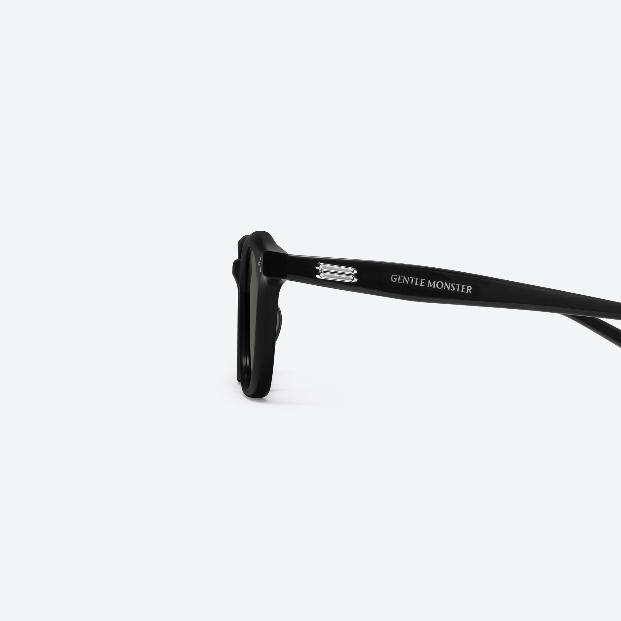 A detailed left view of Gentle Monster Noho 01 Black Acetate framed Round sunglasses.