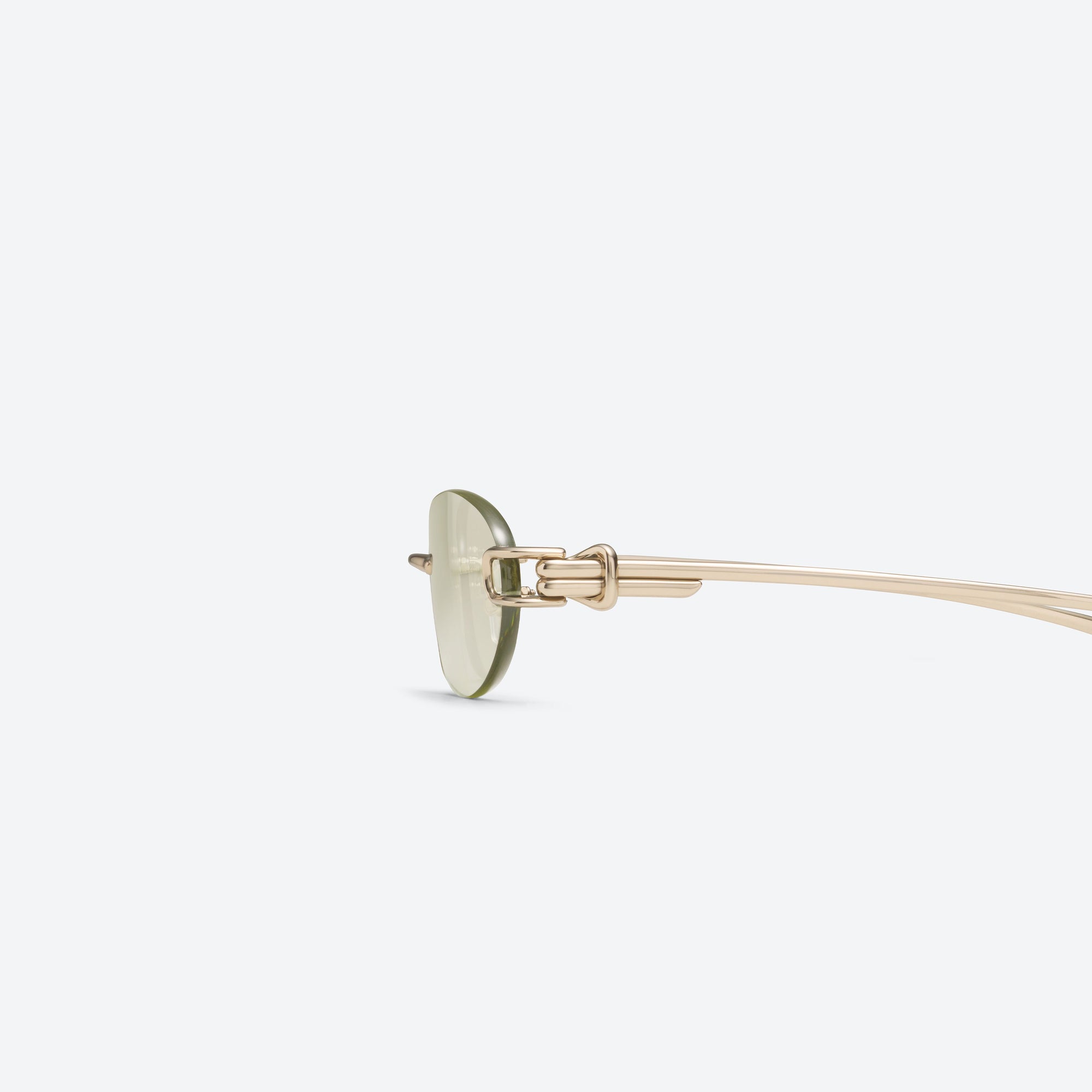 A detailed left view of Gentle Monster Musubi 031 Gold Metal framed Oval sunglasses.