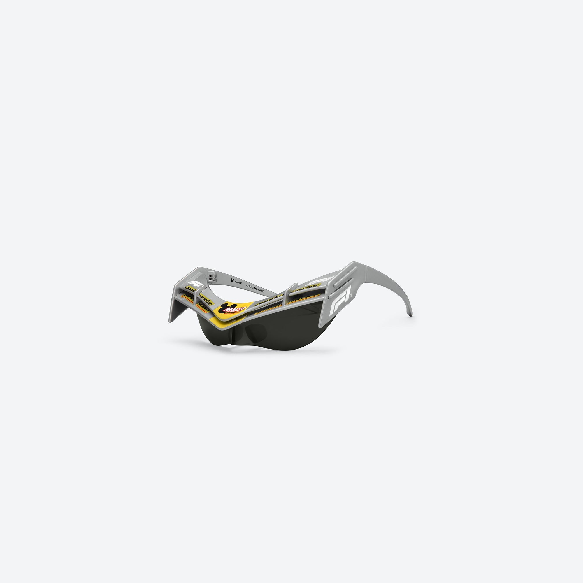45-degree view of Gentle Monster Disney F1 - Wing 4 G21 Gray Nylon framed Wraparound sunglasses.