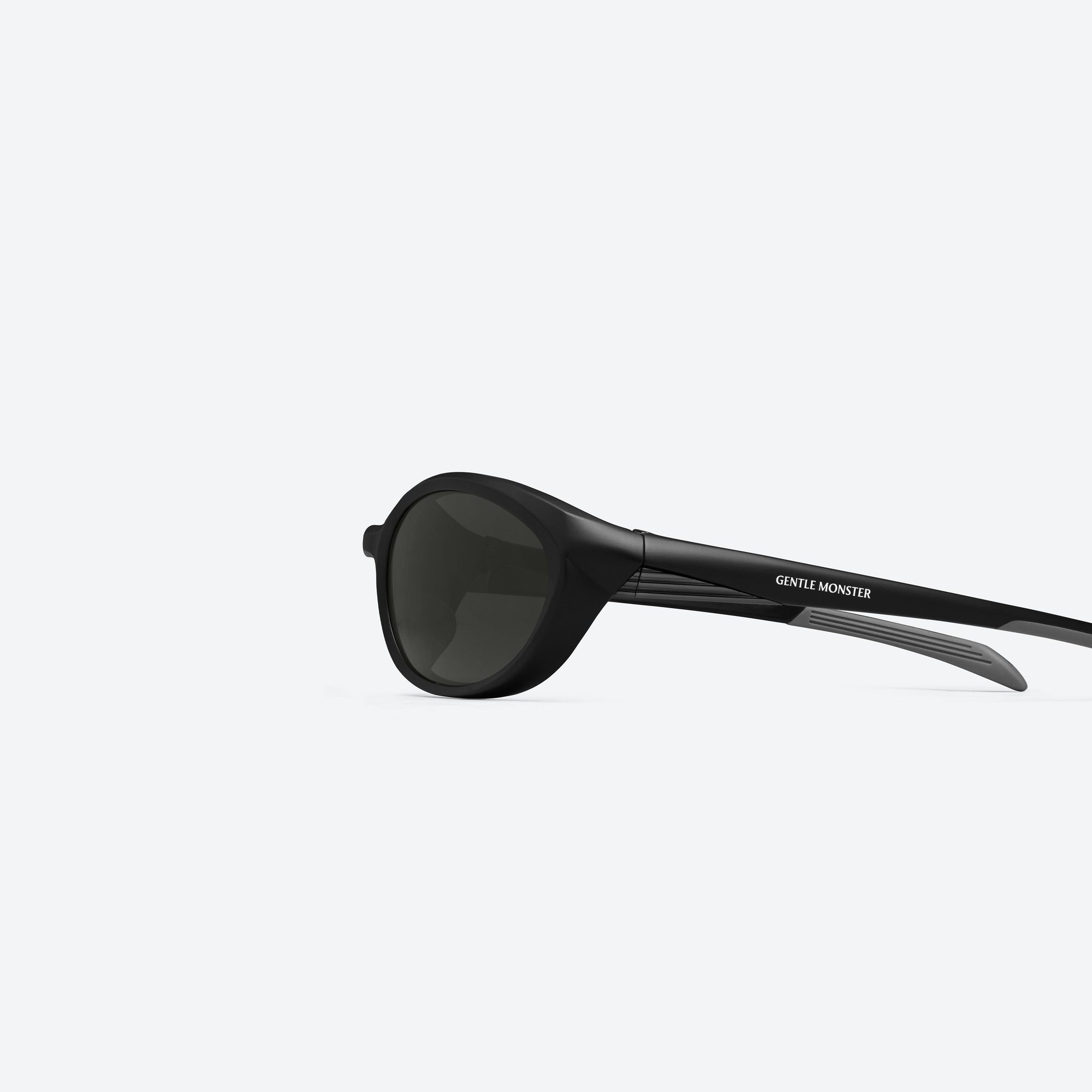 A detailed left view of Gentle Monster Rim M01 Black Nylon framed Wraparound sunglasses.