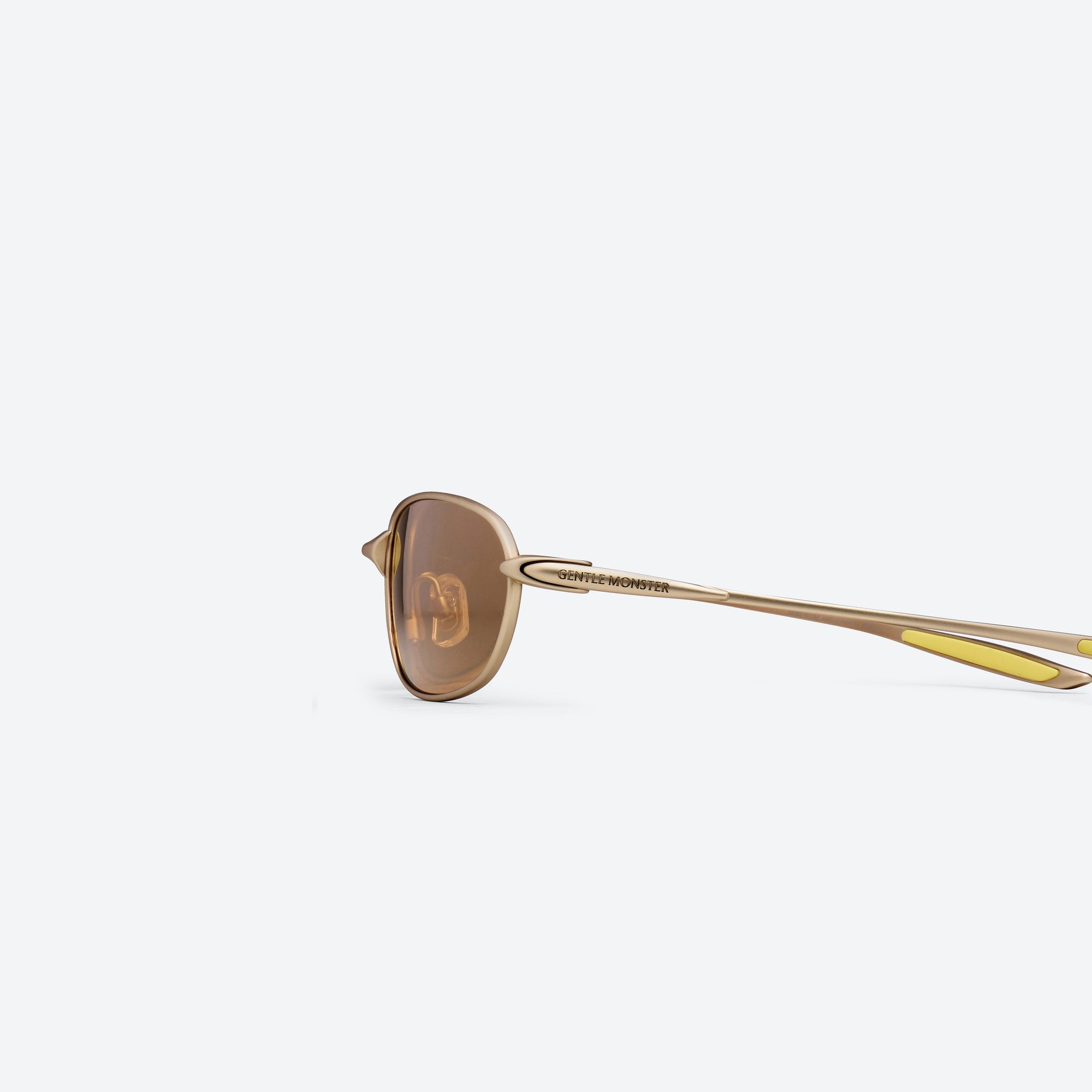 A detailed left view of Gentle Monster Pitot M038 Gold Metal framed Wraparound sunglasses.