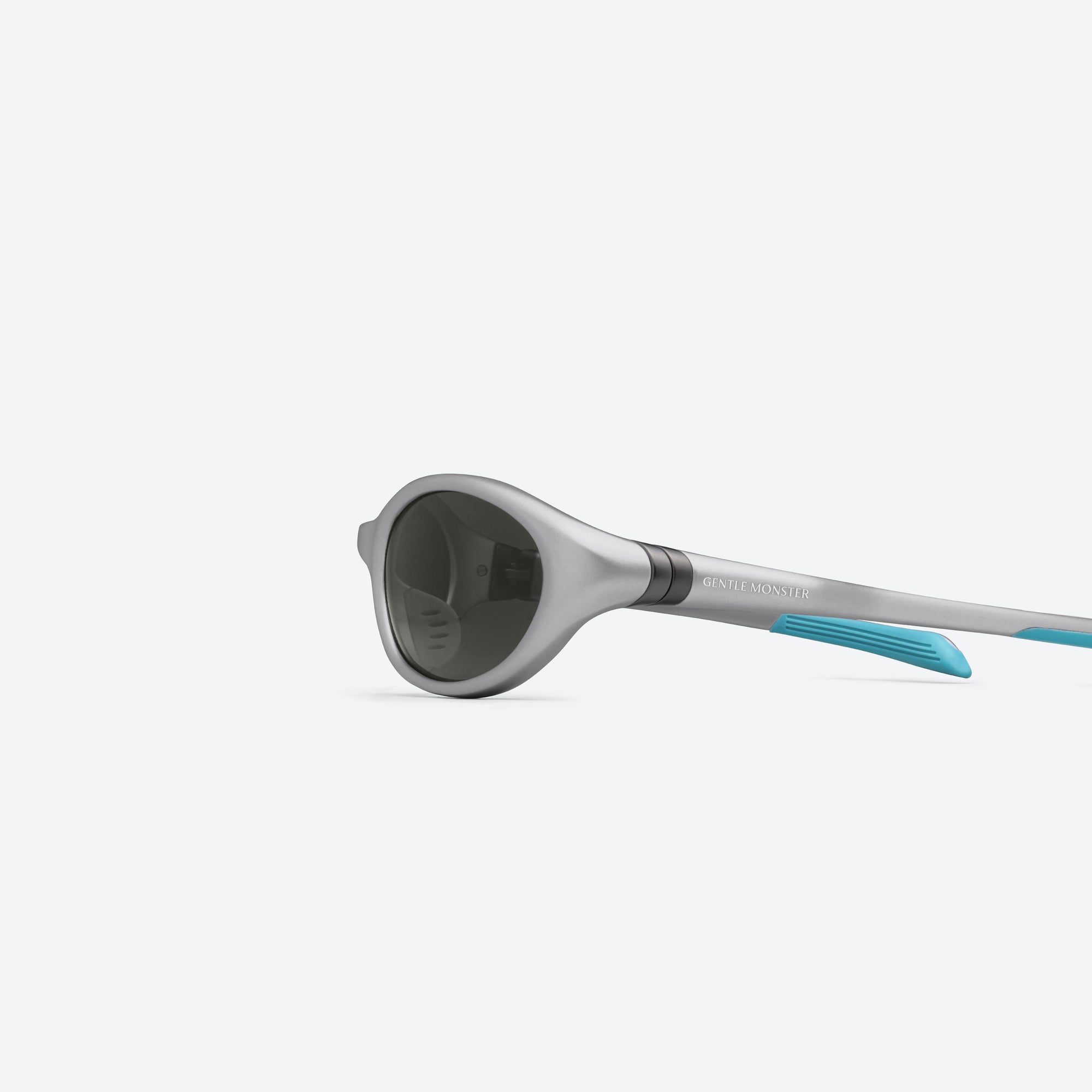 A detailed left view of Gentle Monster Disney F1 - Velo MG21 Gray Nylon framed Wraparound sunglasses.