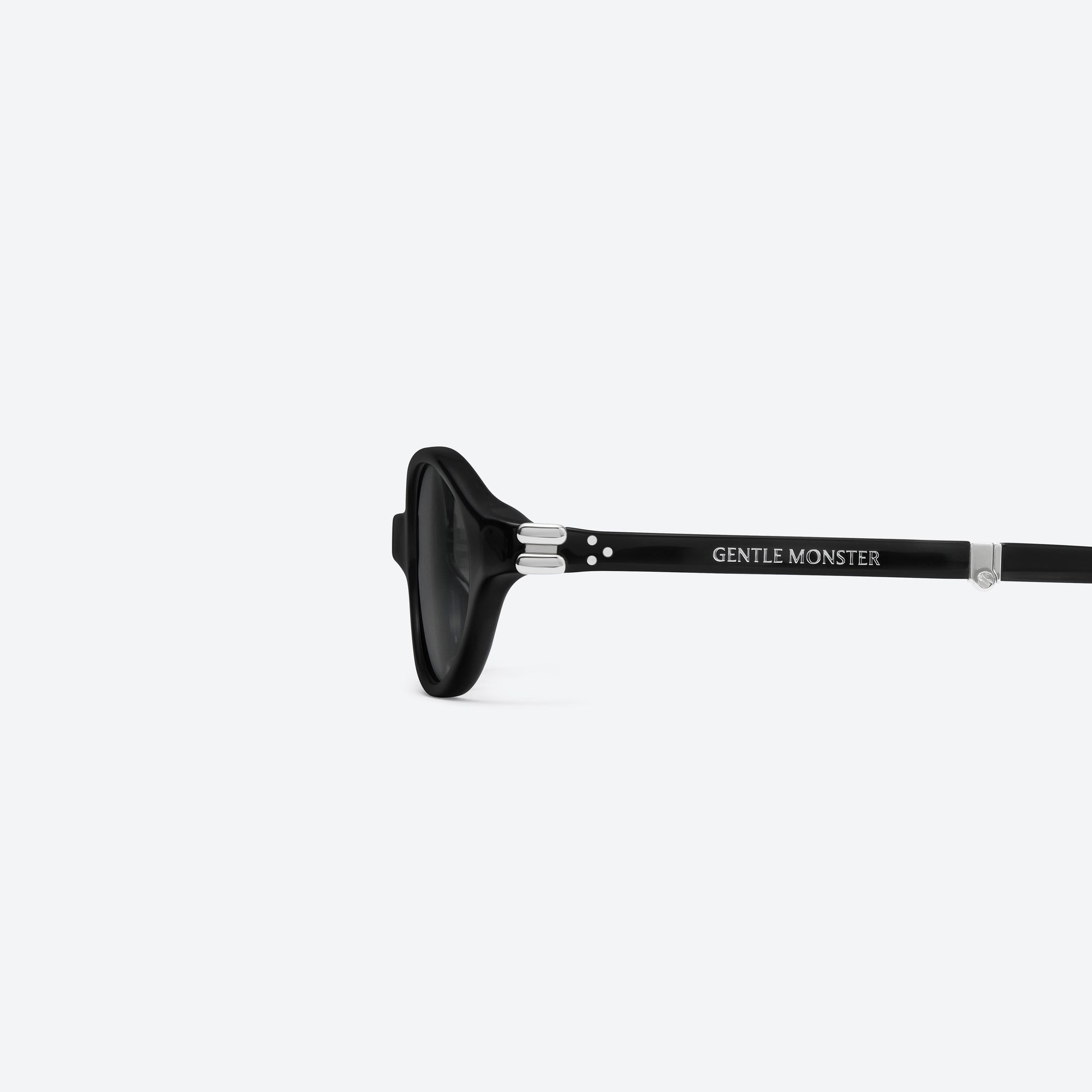 A detailed left view of Gentle Monster Ivy 01 Black Acetate framed Oval sunglasses.