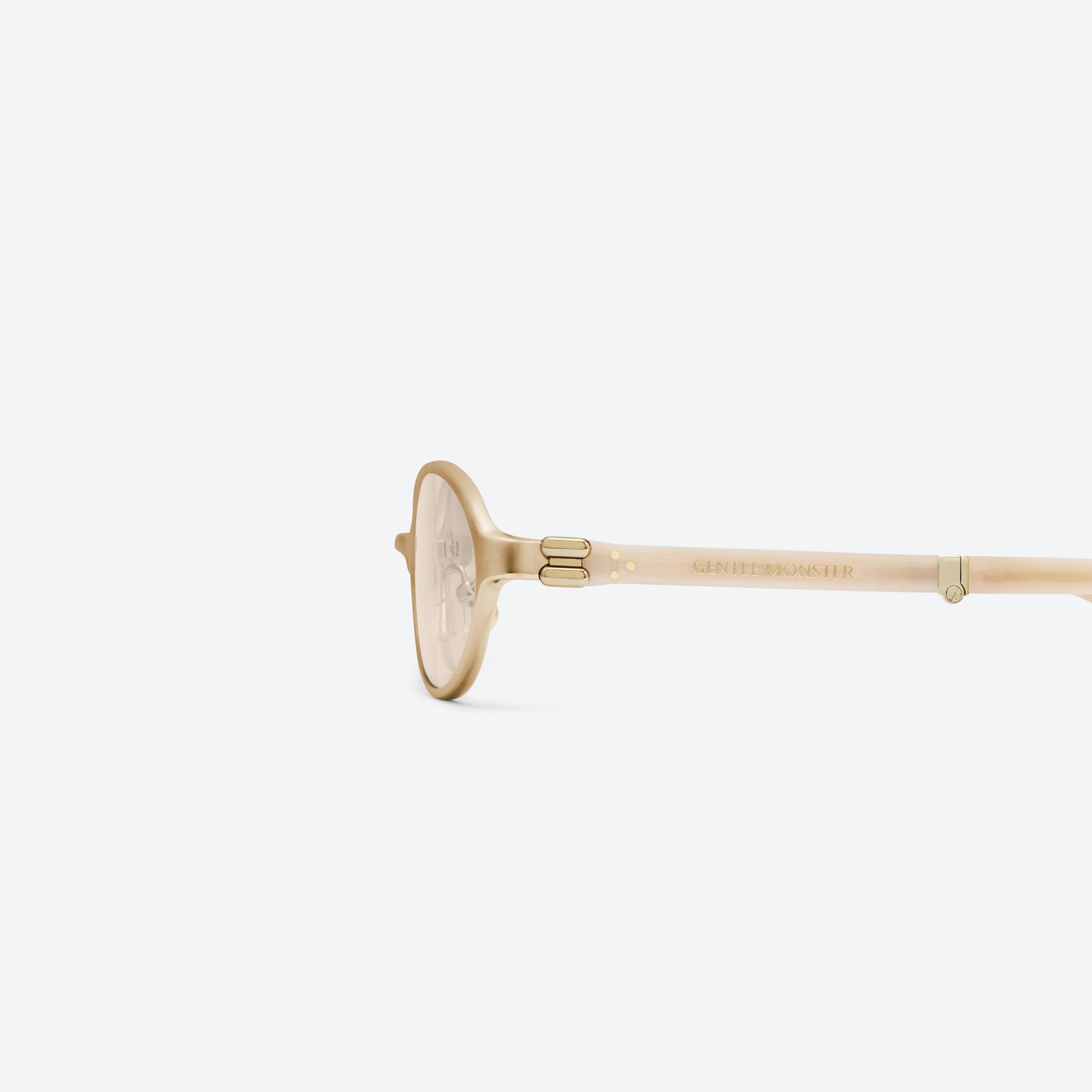 A detailed left view of Gentle Monster Oatt 031 Gold Mixed framed Oval sunglasses.