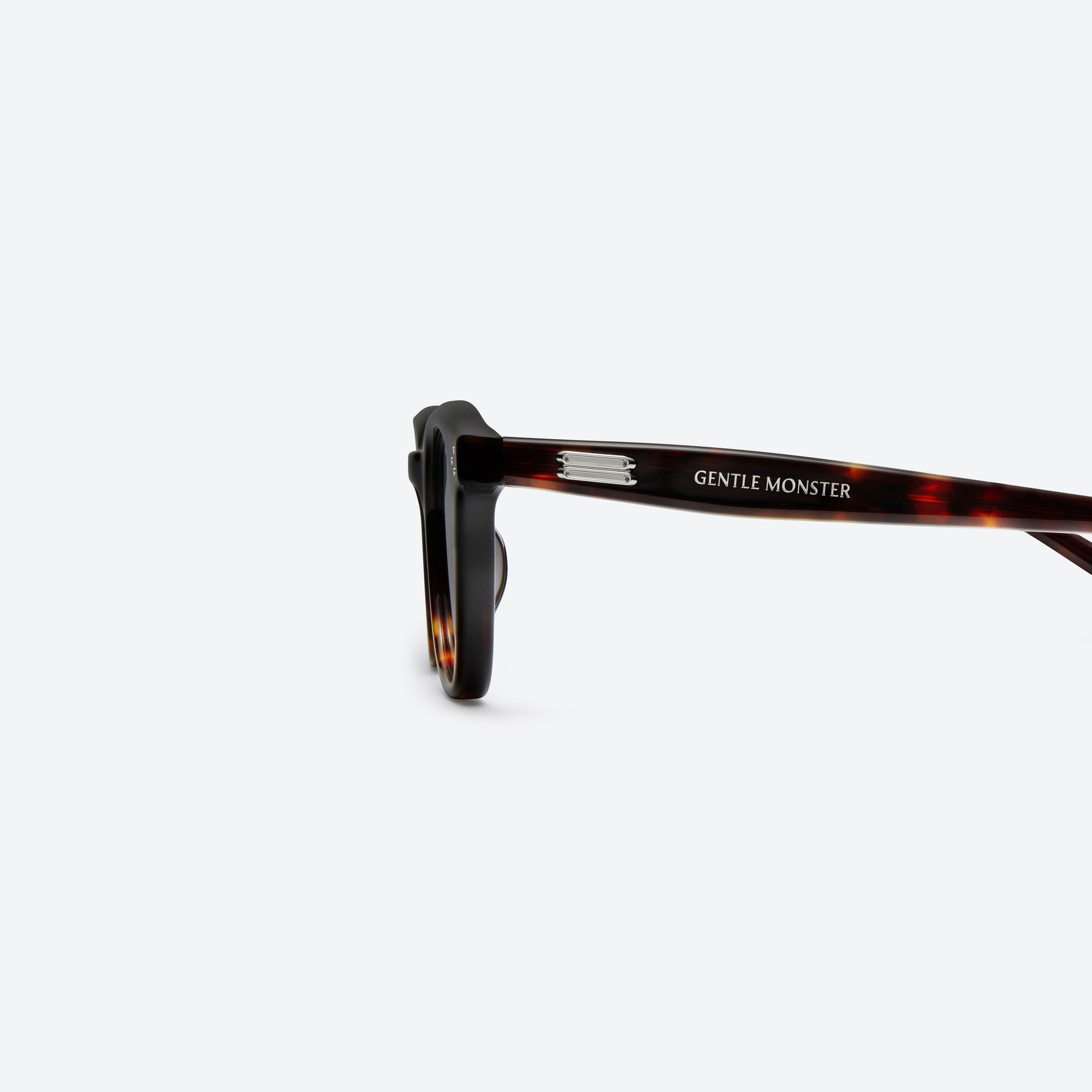 A detailed left view of Gentle Monster Noho.s T1 Tortoise Acetate framed Round sunglasses.