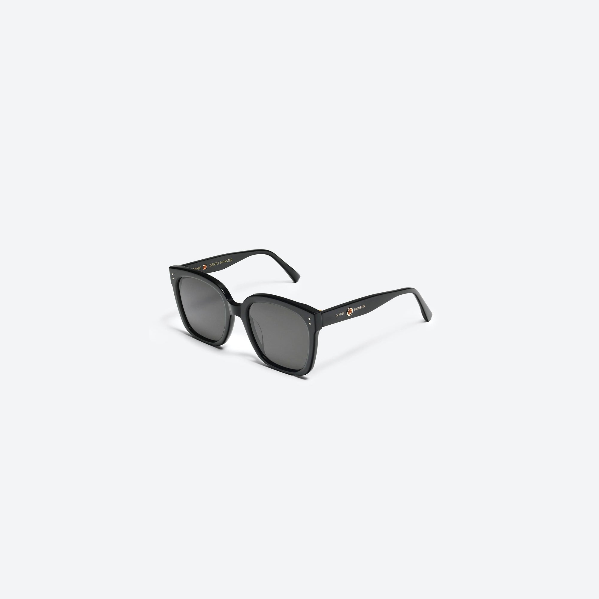 45-degree view of Gentle Monster Jennie - Kuku 01 Black Acetate framed Square sunglasses.